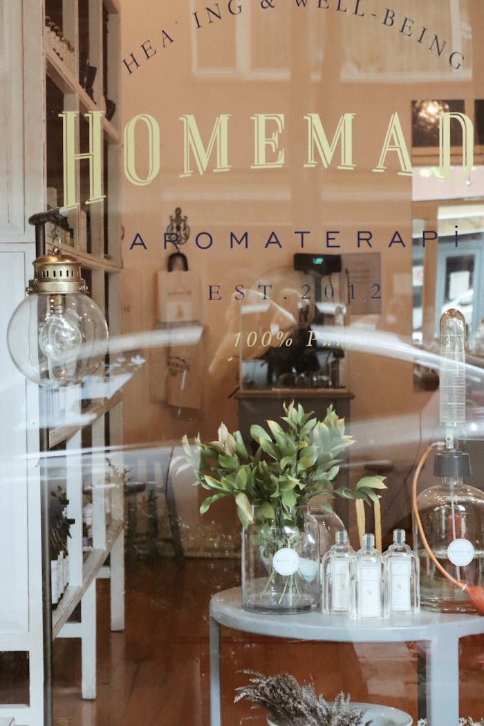 Rustic aromatherapy shop window with decor and wellness products on display.